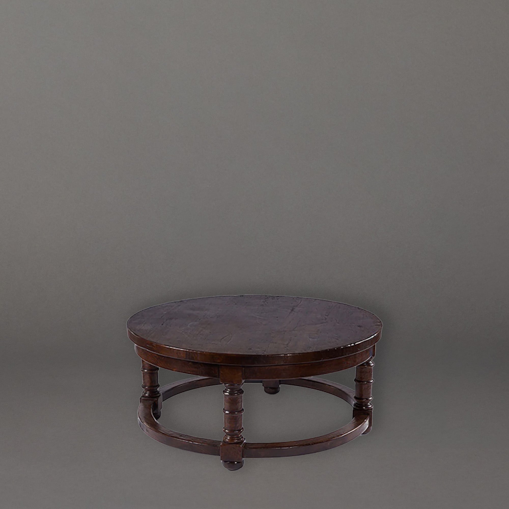 Round wooden table with turned legs on a gray background