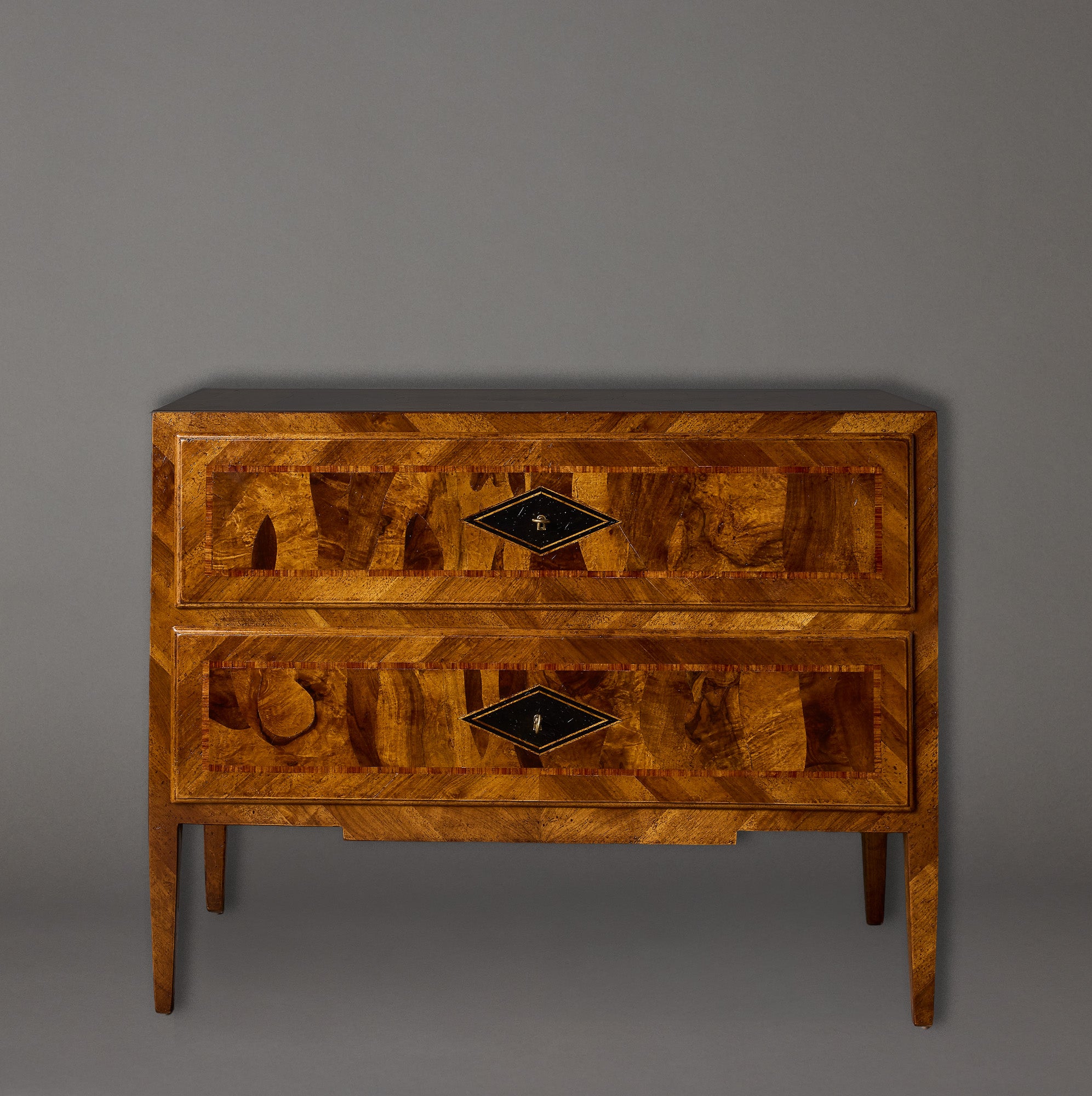 Wooden dresser with intricate design on a gray background
