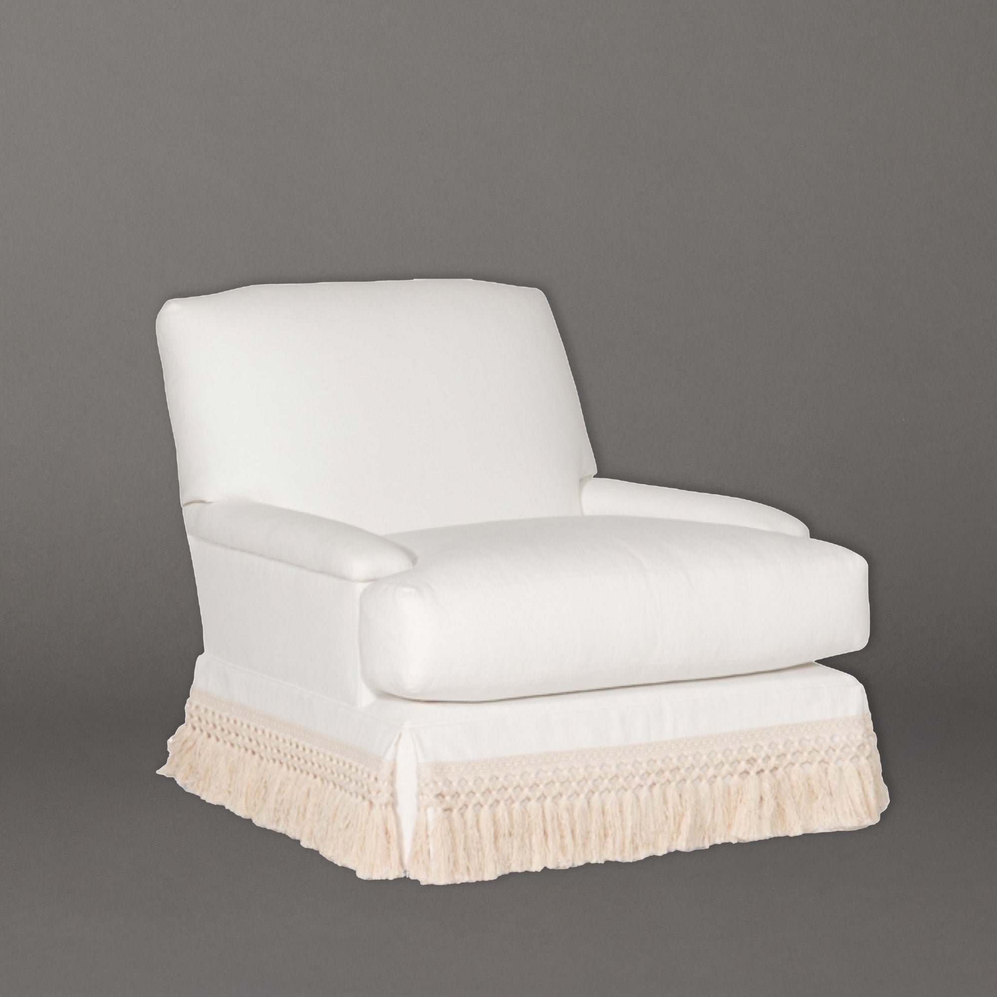 White armchair with beige fringes on a gray background, TinsleyChair by Lee Industries
