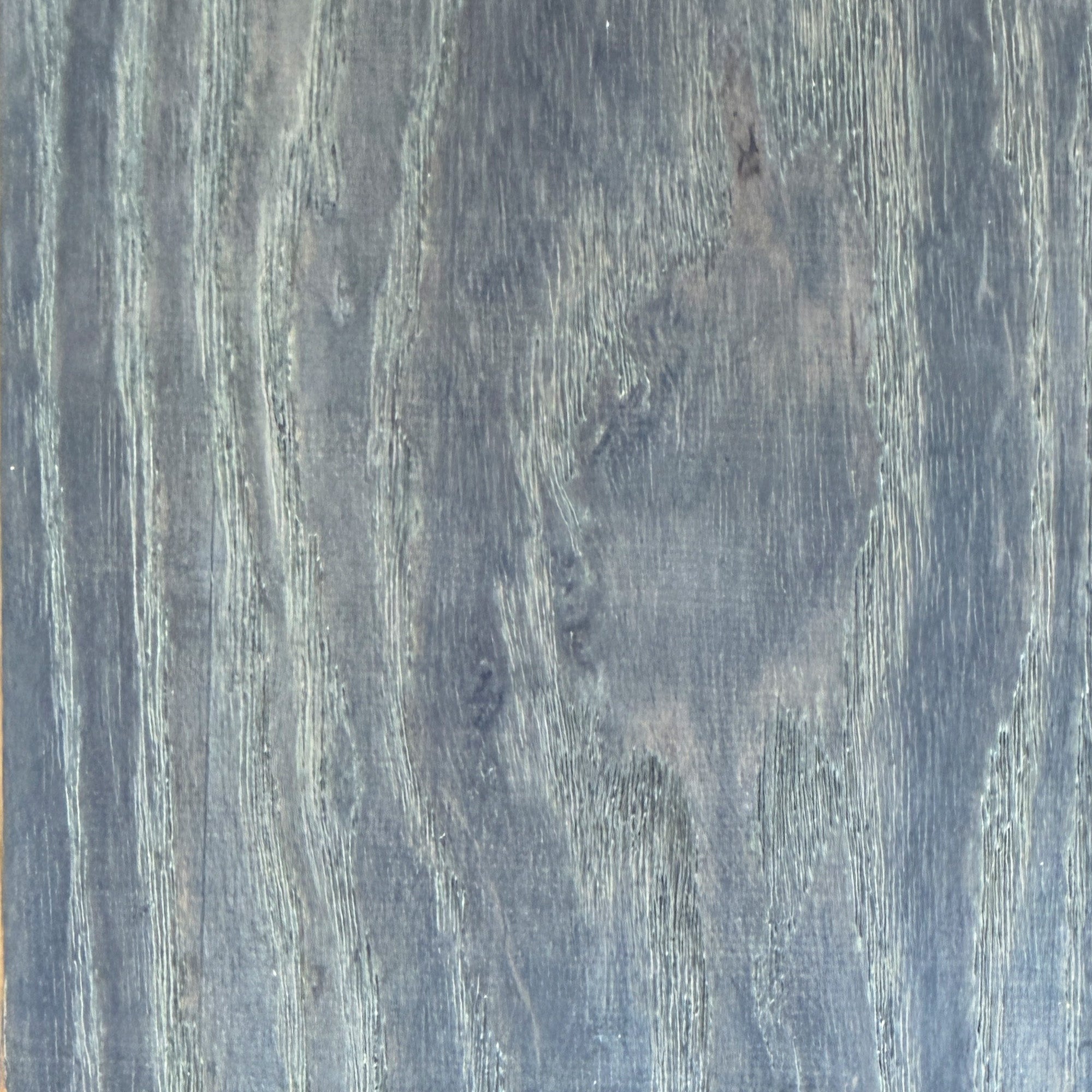 Close-up of a wood grain pattern with dark and light brown colors.