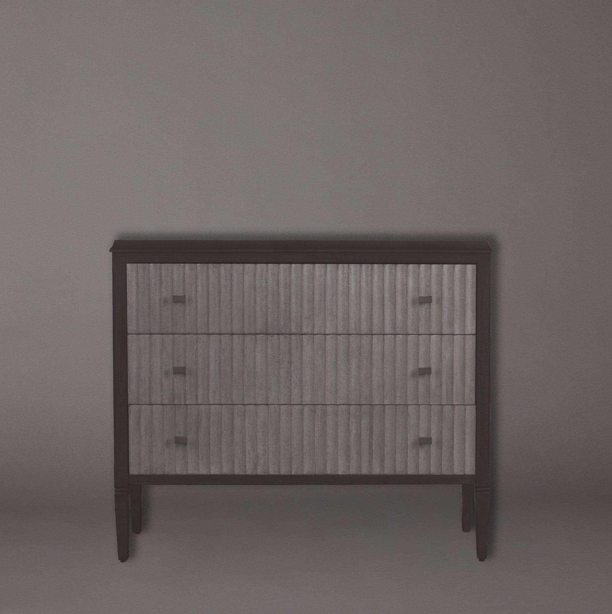 Wooden dresser with metallic finish on a gray background