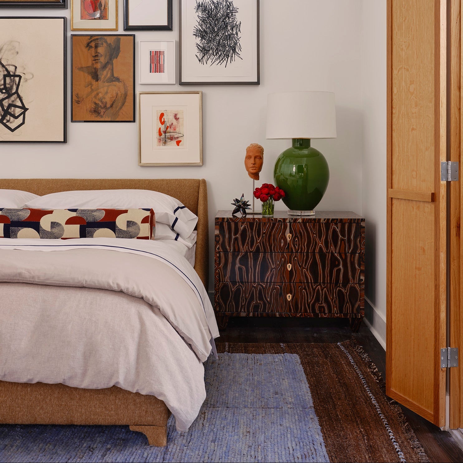 Bedroom with a bed, nightstand, and wall art